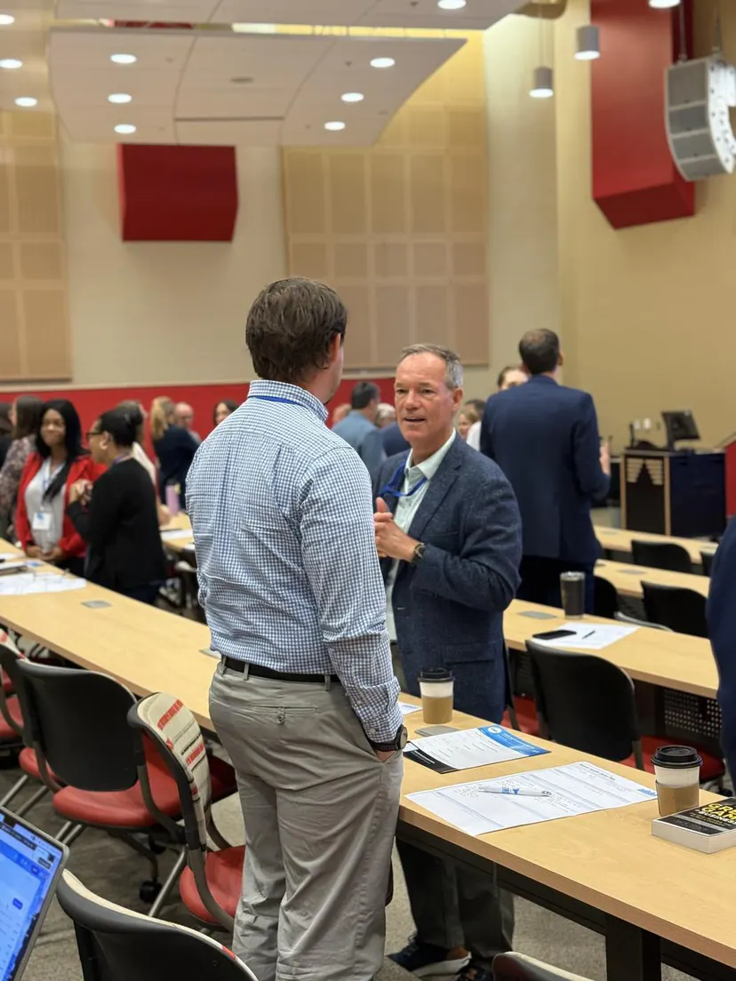 Attendees talking across the room during a break
