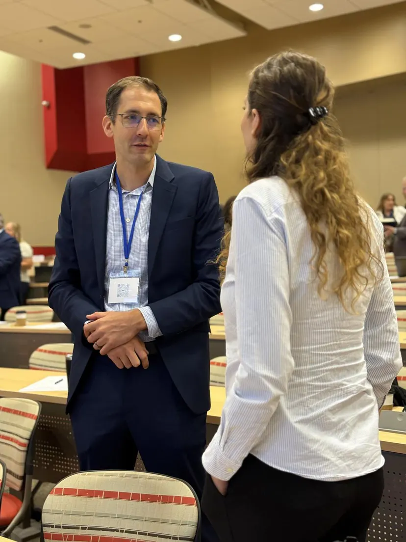 Two attendees talking between sessions